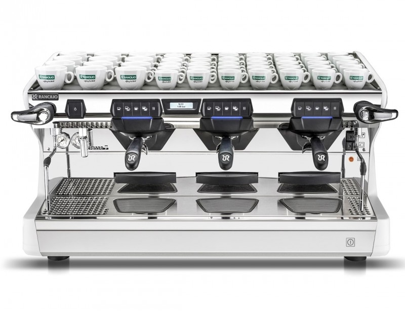 This image is a front view of the Rancilio Classe 7 3 group espresso machine in Ice White, with tall/raised brew group and USB volumetric dosing controls.